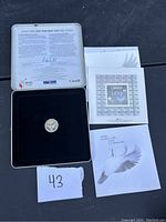 2000 Canadian Millennium $10 silver proof coin displayed in a black velvet presentation box inside a collectible tin. Accompanied by certificate and booklet.