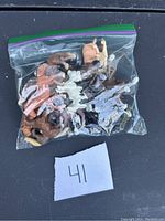Plastic zip bag containing 14 vintage plastic farm animal figurines including horses and cows in assorted colors.