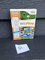 Front of Wii Play game case showing cover art and bonus Wii Remote sticker