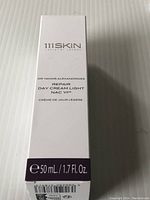 White packaging box front with logo, brand name, and product size details.