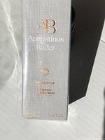 Front of box showing brand Augustinus Bader and product name The Essence, 100ml size, sealed in shrink wrap.
