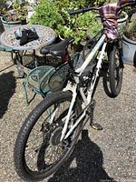 Photo showing rear and side view of CCM mountain bike, white frame, tires, and saddle