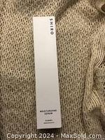 Photo of the front of the white rectangular box with brand name Shiro and product name Moisturizing Serum.