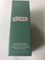 Front of the teal green box showing LA MER branding and product name The Hydrating Infused Emulsion 1.7 fl. oz (50 ml).