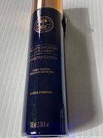 Dark blue 100ml bottle of Neal's Yard Frankincense Intense Hydrating Essence with gold and white lettering on a white background.