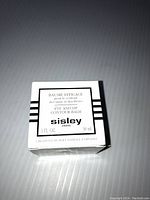 Front view of the Sisley Eye and Lip Contour Balm box showing product name, size, and branding.