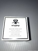 Front view of the Sisley Paris Eye and Lip Contour Balm box showing product name and branding.