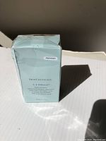 Front of sealed SkinCeuticals C E Ferulic 30 ml box on white surface with shrink wrap intact, showing ‘Prevent’ sticker and product name.