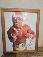 Framed photo of Hulk Hogan with autograph visible, showing upper body and signature area.