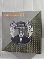 Box with Emblazon of Knife logo and design showing winged skull artwork and product name.