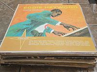 Photo showing album cover of Eddie Heywood Jumpin Keyboard record with colorful illustration and title.