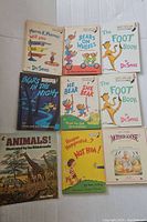 Books laid out on a white surface showing Dr. Seuss and Bears series titles, plus Mother Goose and animals book.