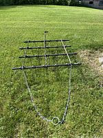 Overall front view of the metal drag harrow with chain hitch extended