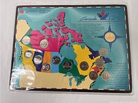 Complete coin set displayed in original packaging with a map of Canada highlighting the provinces.