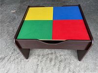 Kidkraft Lego table with LEGO-compatible top divided into four sections colored yellow, blue, green and red.