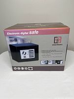 Front view of unopened box of Guardwell electronic digital safe showing product image, brand, and features.
