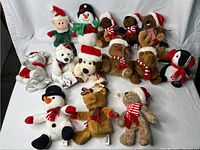 Full collection of 14 Sears holiday-themed plush animals and figures, arranged on white background showing variety of characters and seasonal attire.