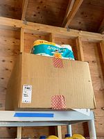 Box with 12 family rolls of Angel Soft toilet paper on top of a sealed brown box.