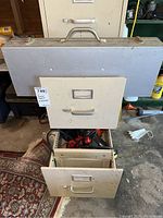 Closed metal file cabinet and drawer system storing power tools.