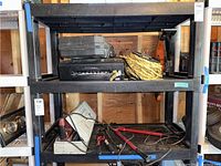Lot contents on black shelving including items listed by seller: rope, Dewalt case, Brother printer, bolt cutters, reciprocating saw.