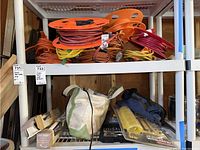 Boxed Safety First 16 inch assist bars stacked on shelf next to a green and white tool bag and other tools.