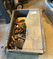 Photo of a large plastic bin filled with loose vintage baseball cards and some toys; view from above showing the bin content.