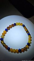 Top-down view of the gemstone stretchy bracelet showing an alternating pattern of amber, lapis lazuli, and yellow agate beads