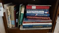 Photo showing a stack of assorted books including 'The Art of Manliness', 'Chicken Soup for the Soul: Think Positive', and others.