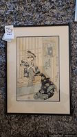 Full view of framed Japanese woodblock print showing seated geisha in kimono