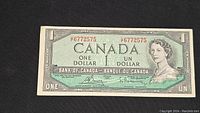 Full front view of the 1953 Canadian one dollar bill showing its serial number, denomination, bilingual text, and Queen Elizabeth II portrait