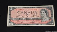 Front view of the 1954 Canadian two-dollar bill showing the portrait of Queen Elizabeth II and serial number.