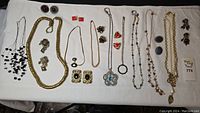 Full overview of all jewelry pieces including necklaces, earrings with semi-precious stones and costume jewelry.