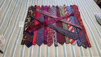 All 10 men's ties laid out flat showing front patterns and colors