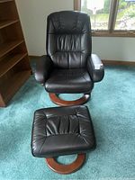 Benchmaster Euro style swivel recliner with matching ottoman, showing the full set from a front view.
