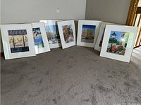 Seven framed prints arranged on floor, showing overall lot contents