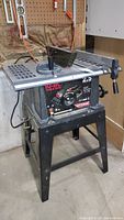 Front view of the Craftsman 10 inch table saw with visible power dial, brand label, and metal stand.