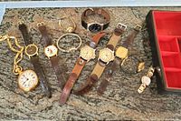 Full layout of 10 men's and women's watches including pocket and wristwatches on a textured surface.