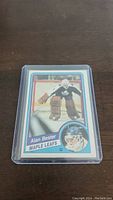 Front of Alan Bester rookie hockey card showing player in goalie gear in action pose with Maple Leafs branding