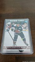 Front view of Alex Newhook Young Guns rookie hockey card in protective case.