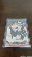 Front side of Isaac Ratcliffe Young Guns rookie hockey card showing the player in action on ice in Philadelphia Flyers uniform.