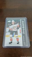 Front of Jamie Drysdale Young Guns Rookie hockey card in protective case showing player image and branding.