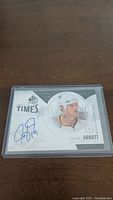 Front of Jason Arnott autographed hockey card, showing player image and blue signature