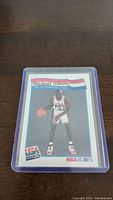 Front of Michael Jordan USA basketball card in protective sleeve showing Jordan in Team USA uniform with ball.