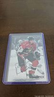 Front of Rob Zamuner hockey card showing player in Ottawa Senators uniform with autograph.