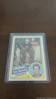 Front of Tom Barrasso rookie hockey card in protective plastic sleeve showing player in net with action and headshot