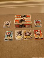 Sealed box of 2008-2009 Upper Deck Collector's Choice hockey trading cards with six loose hockey cards arranged in front showing various NHL players.