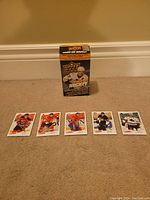 Front view of the Upper Deck box for hockey cards and five individual hockey trading cards from the 2008/09 series laid out in front.