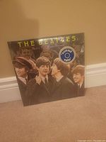 Front cover of The Beatles 'Rock & Roll Music' vinyl album featuring a black and white image of the band members and a sound pallu sticker