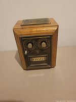 Front view of the replica locking bank showing combination dials, knob, and serial style number display.