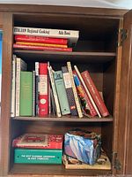 Full view of cookbooks on shelves showing spines and front covers, some titles visible.